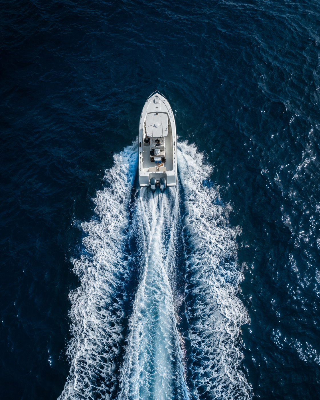 Aerial view of a boat running on Lake Erie, leaving a long wake
