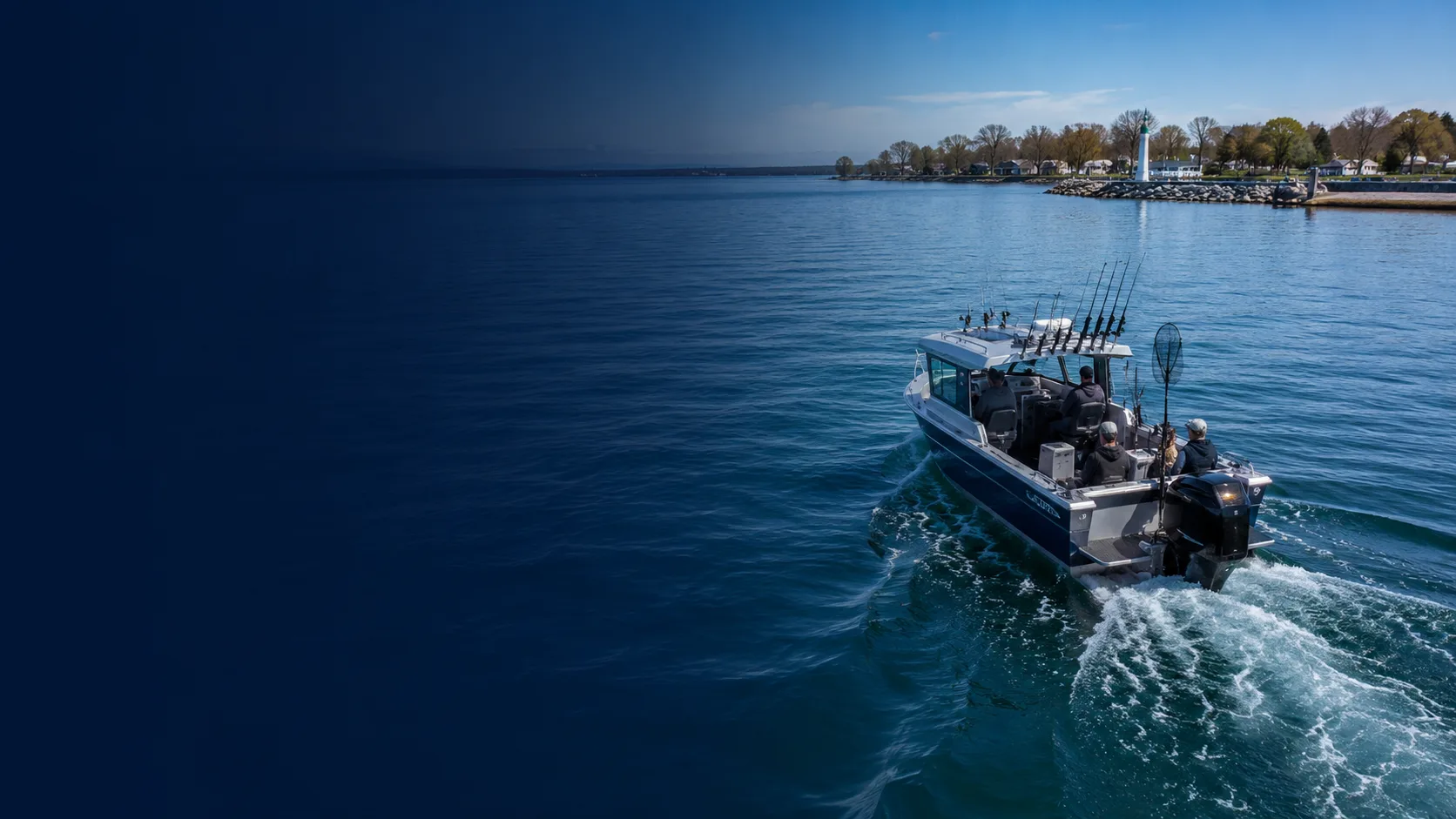 A fishing boat running on Lake Erie past a harbour breakwall and lighthouse