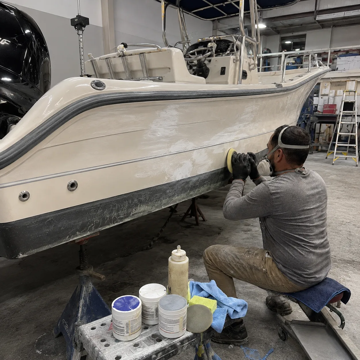 Hartzel Marine technician buffing and restoring the gelcoat on a boat hull