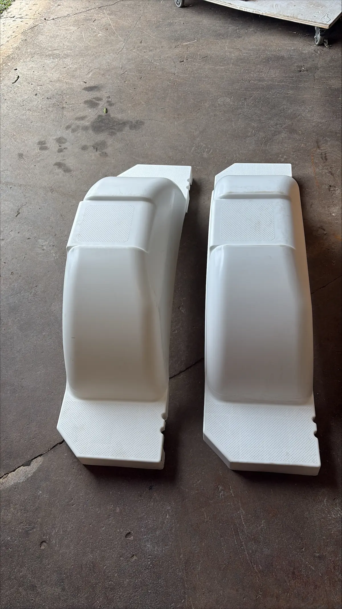 Pair of new white boat trailer fenders with step tops at Hartzel Marine in Dunnville