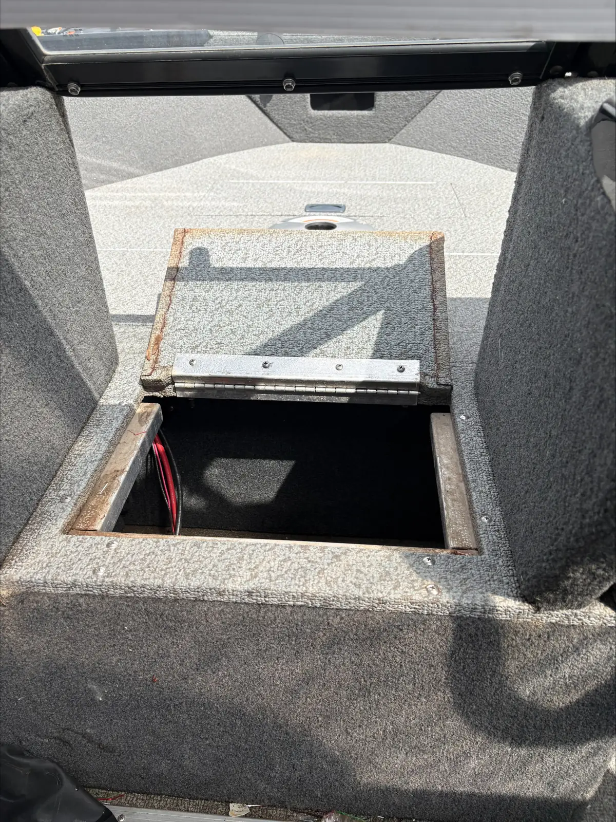 Open storage compartment in the casting deck of the 2023 Legend XTE Sport 18