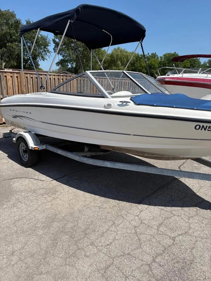 Bayliner 175 Bowrider from the side with the bimini top extended