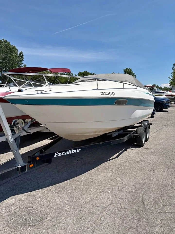 1995 Wellcraft 236 Eclipse on its trailer, white hull with teal stripe